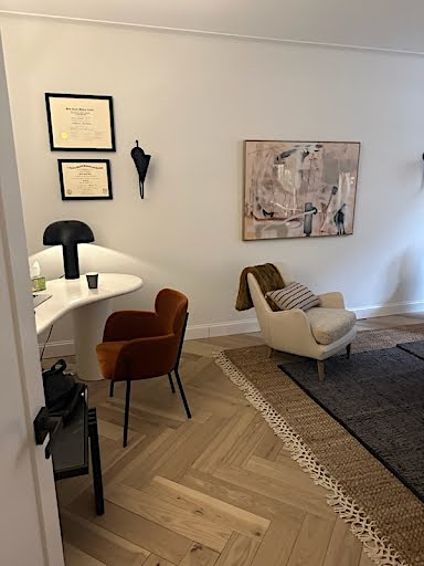 Office space with furniture, rug, and wall decorations